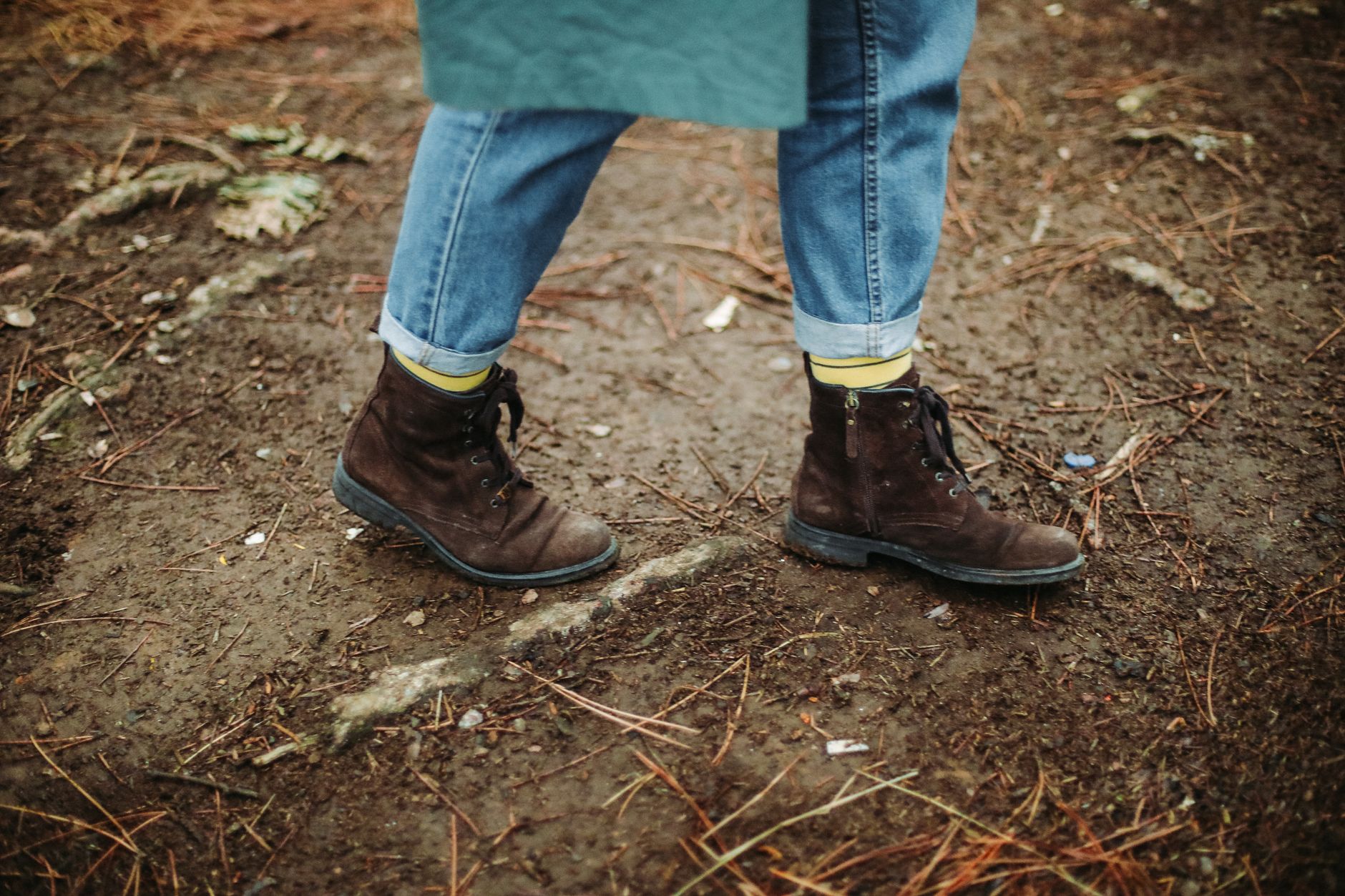 Weatherproof dark fashion UK winter boots in festival mud — chunky black leather platform boots