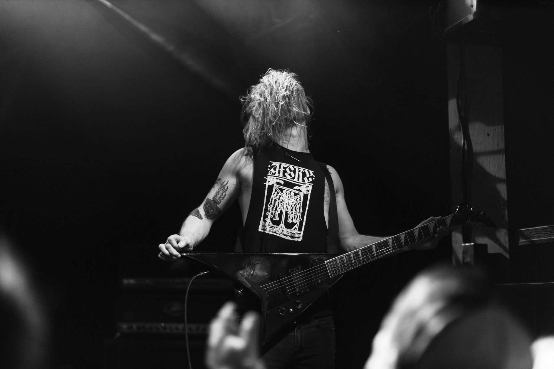 Heavy metal guitarist performing live, representing the metal side of orchestras collaborating with metal bands